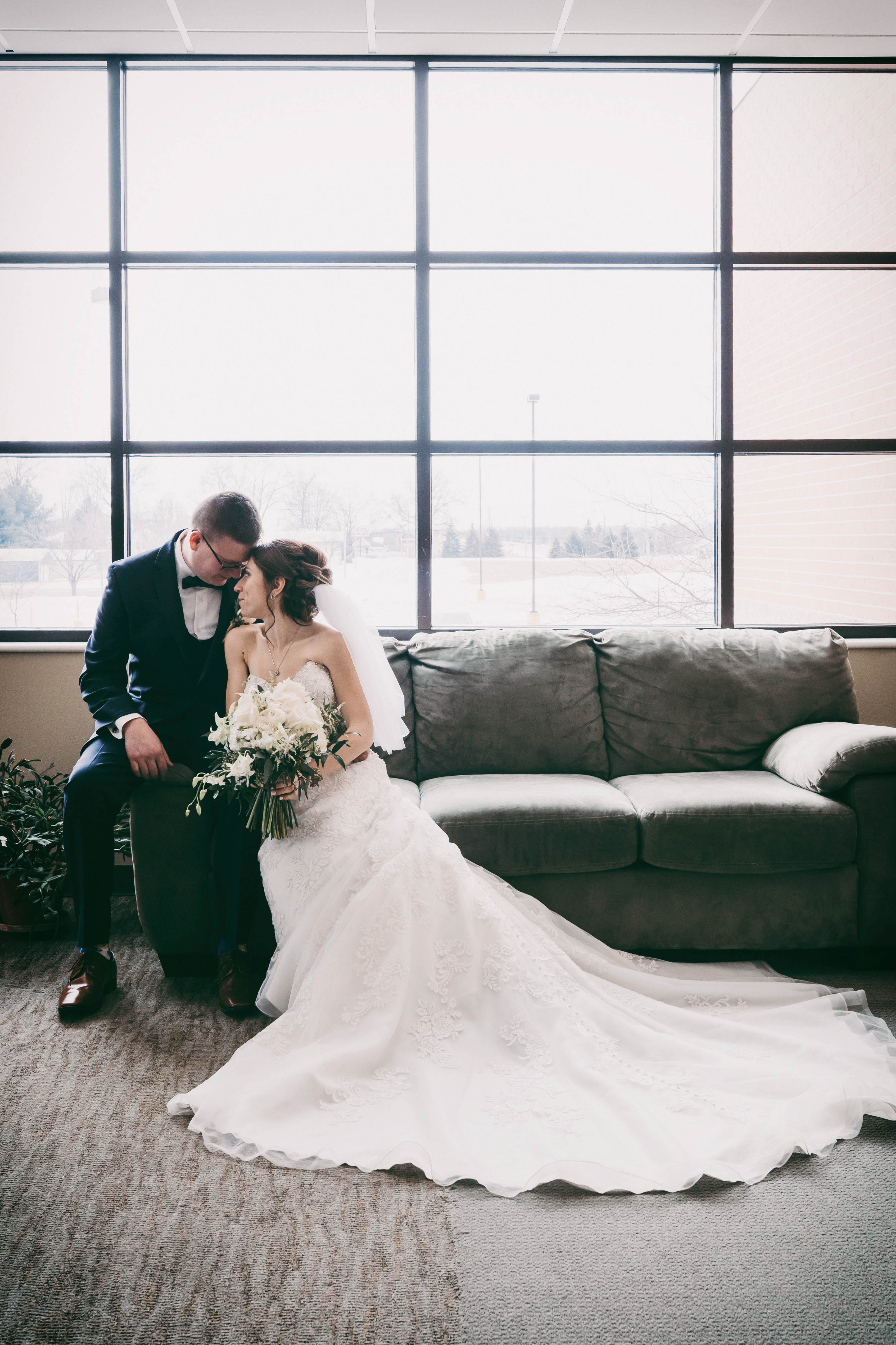 bride and groom on a couch
