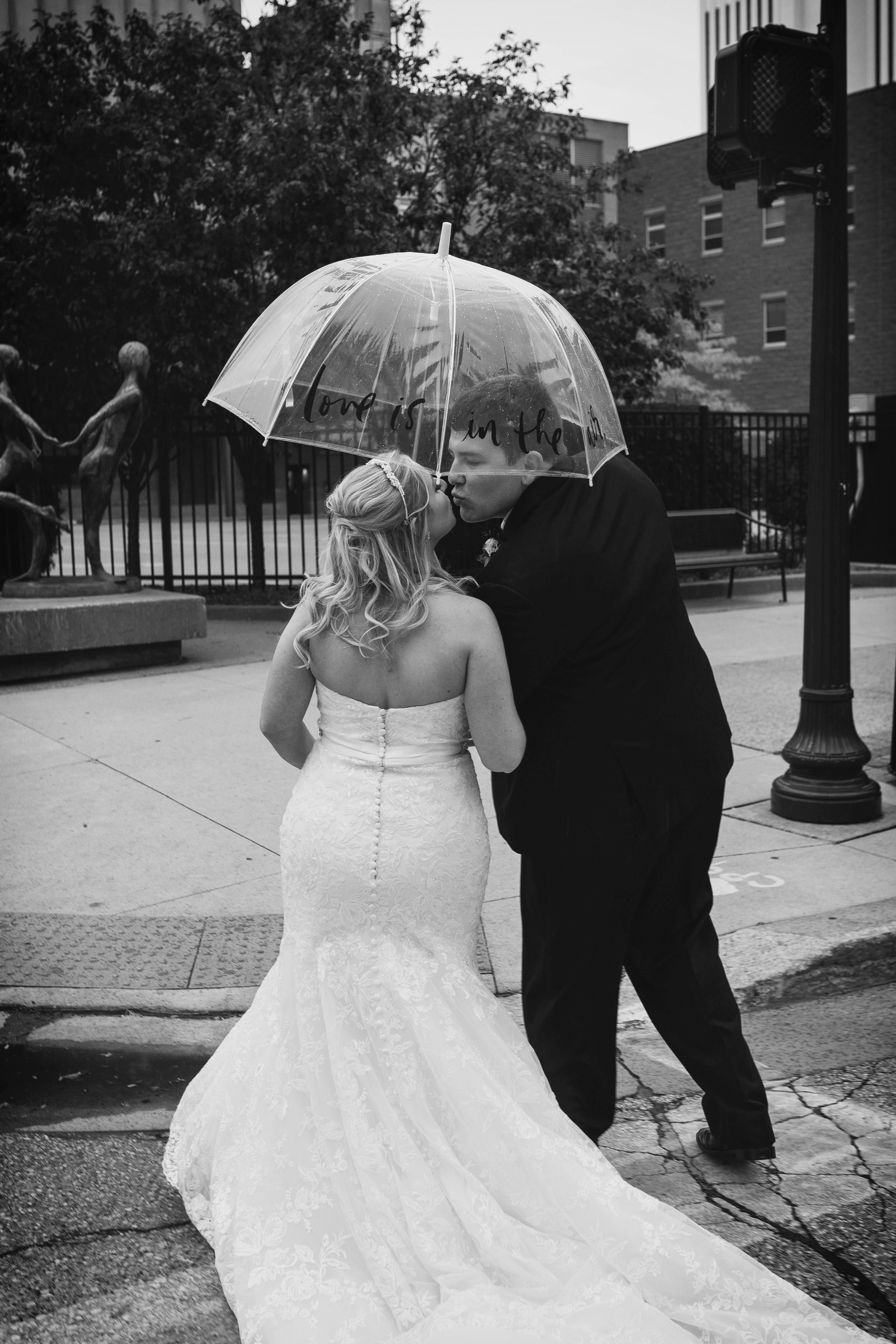 kissing in the street in the rain