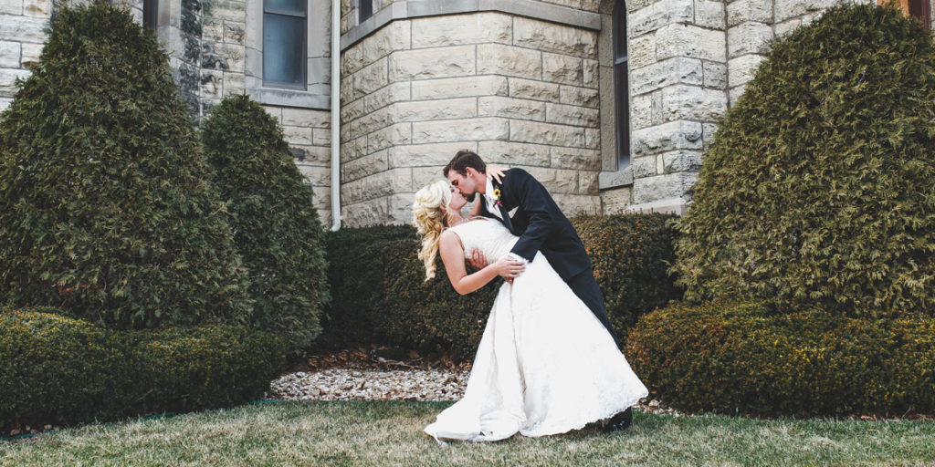 groom dipping bride for a kiss