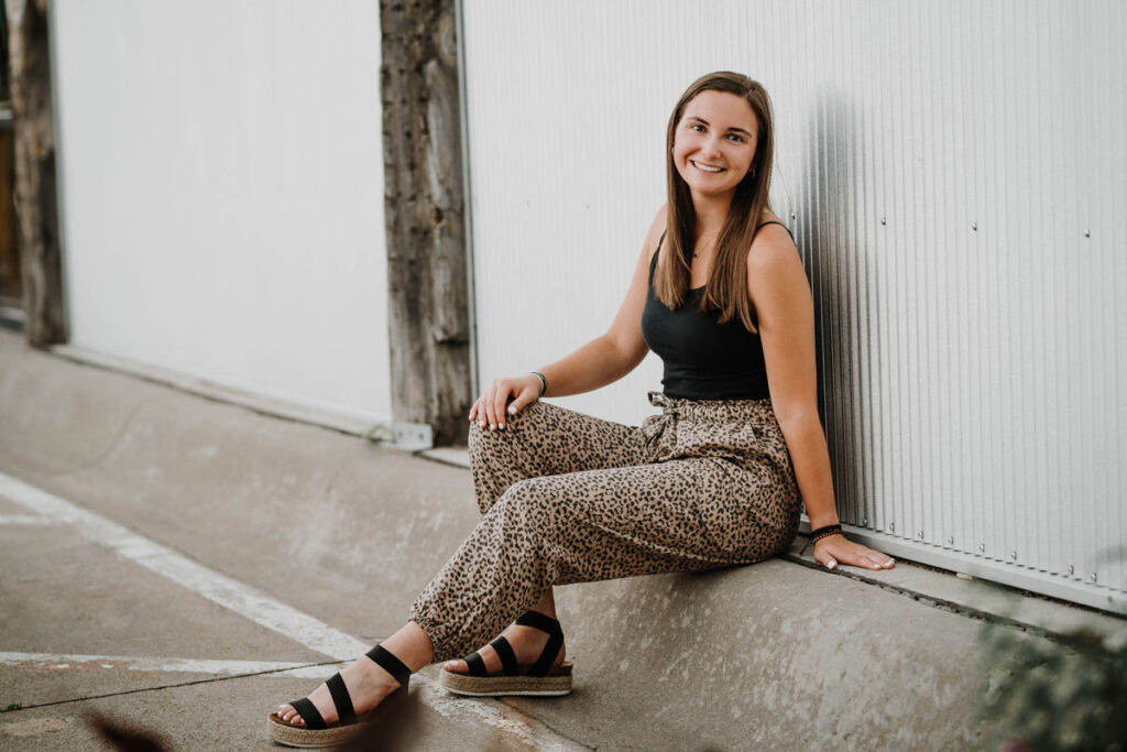 Senior sitting on a parking curb