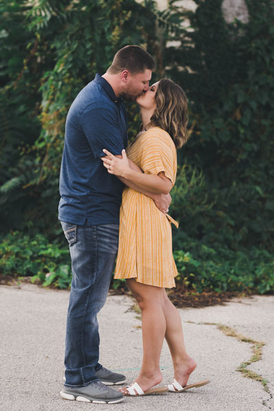 engaged couple kissing