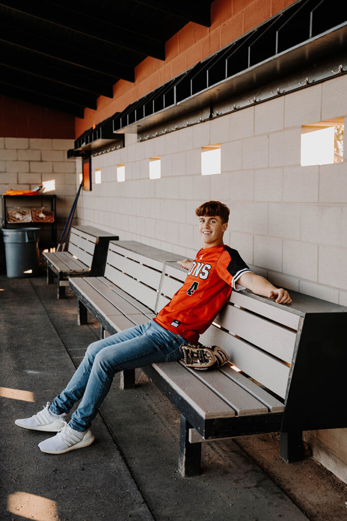 senior in baseball dugout